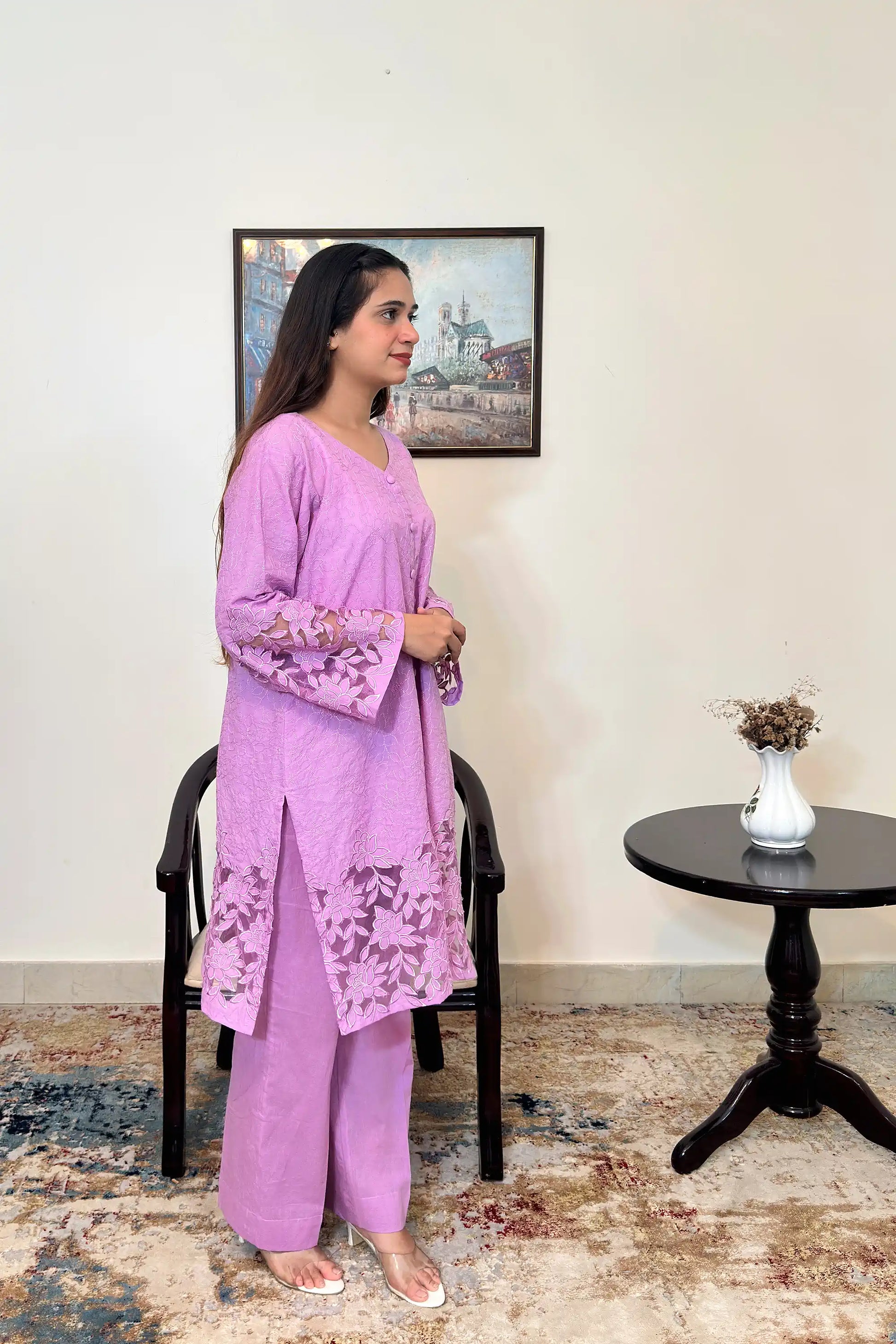 Side view of a purple cotton straight kurta worn with purple trousers, featuring floral cutwork embroidery at the sleeves and hem.