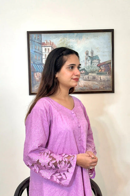 Side view of a purple cotton straight kurta, featuring floral cutwork embroidery on the sleeves and button placket.