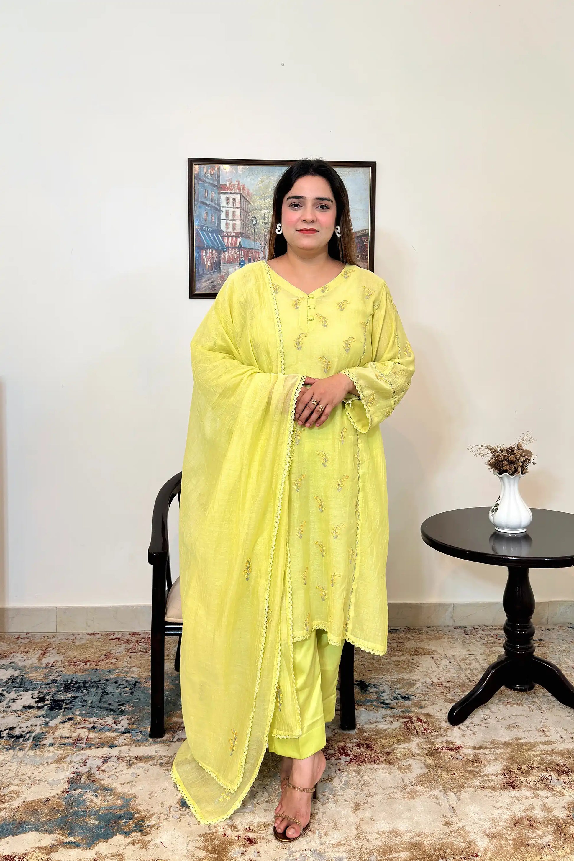 Front view of a lemon-yellow chanderi kalidar kurta with dupatta on, featuring floral resham embroidery scattered across the kurta and dupatta, paired with lemon-yellow trousers.