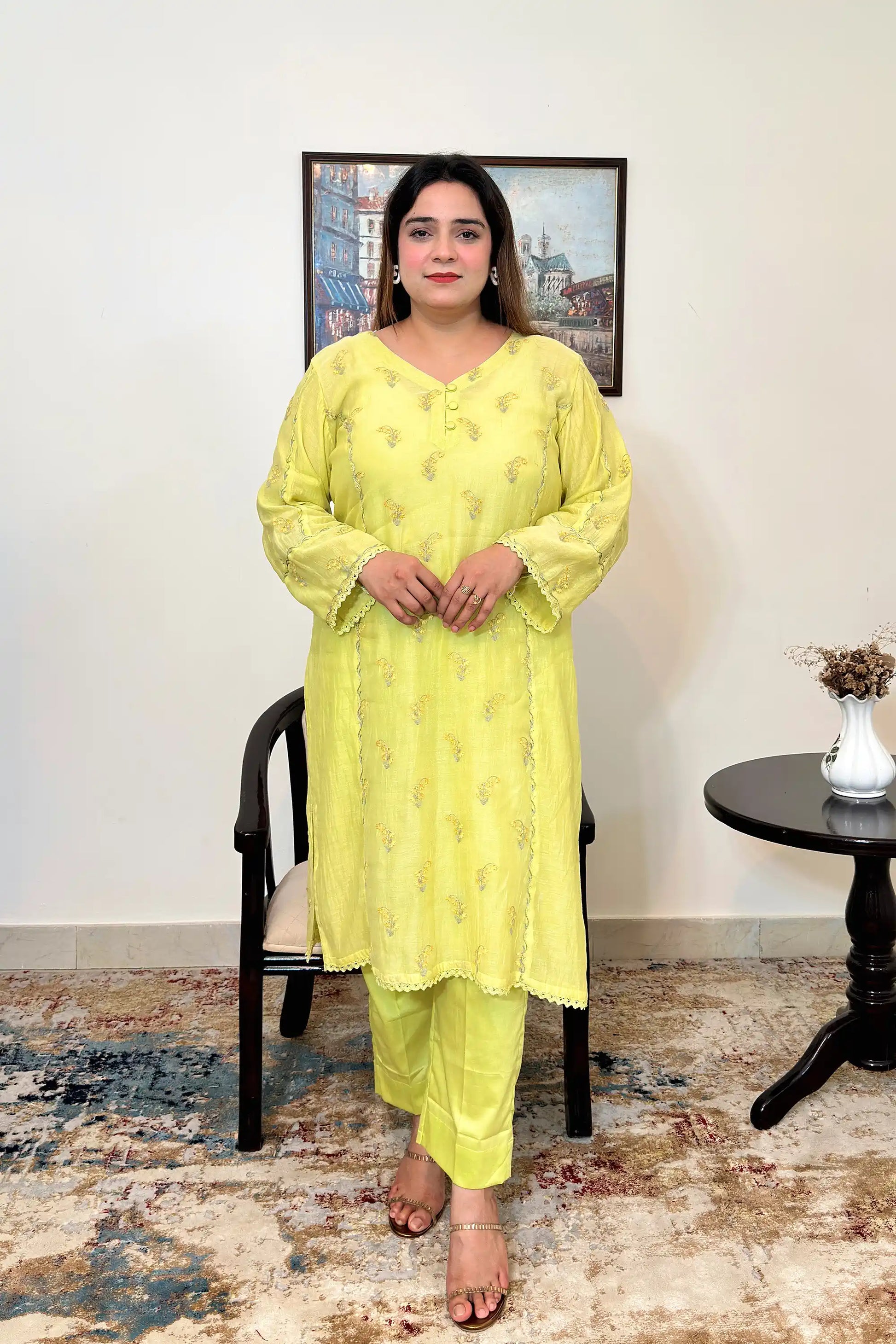 Front view of a lemon-yellow chanderi kalidar kurta, showing floral resham embroidery and matching lemon-yellow trousers.