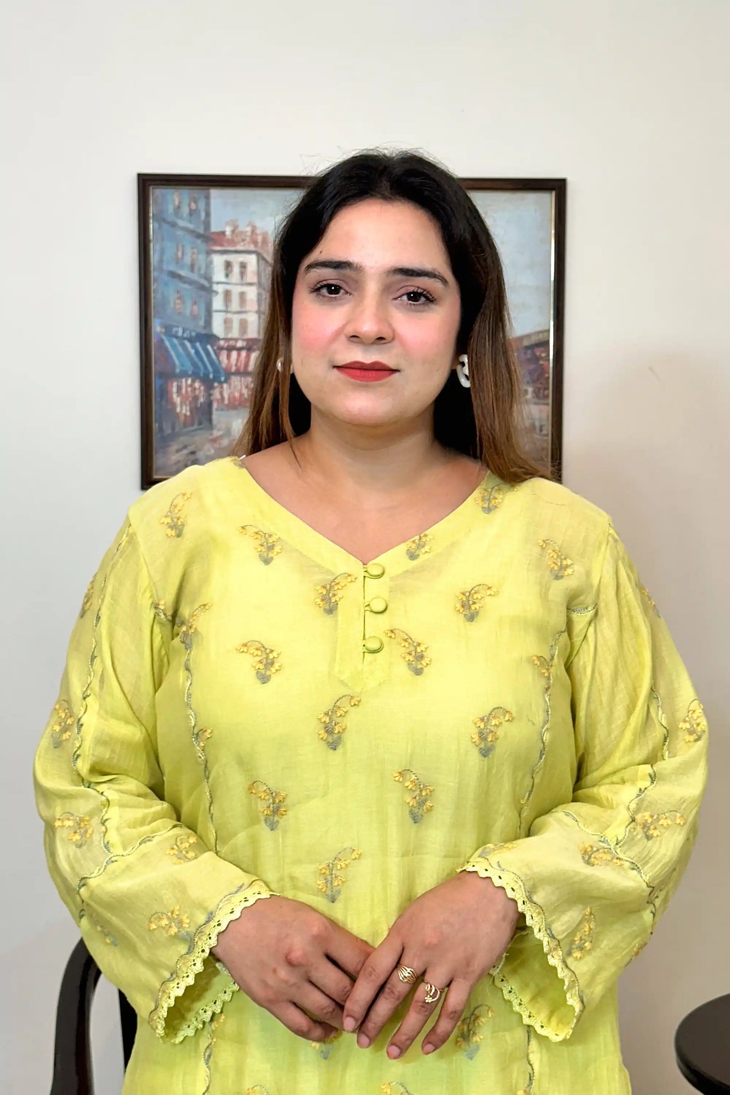 Front view close-up of a lemon-yellow chanderi kurta, showing floral resham embroidery around the button placket and sleeves.
