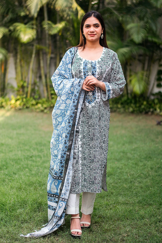 Front view (full suit, top to bottom): Model wearing a black printed linen kurta with applique work, off-white trousers, and a matching dupatta.