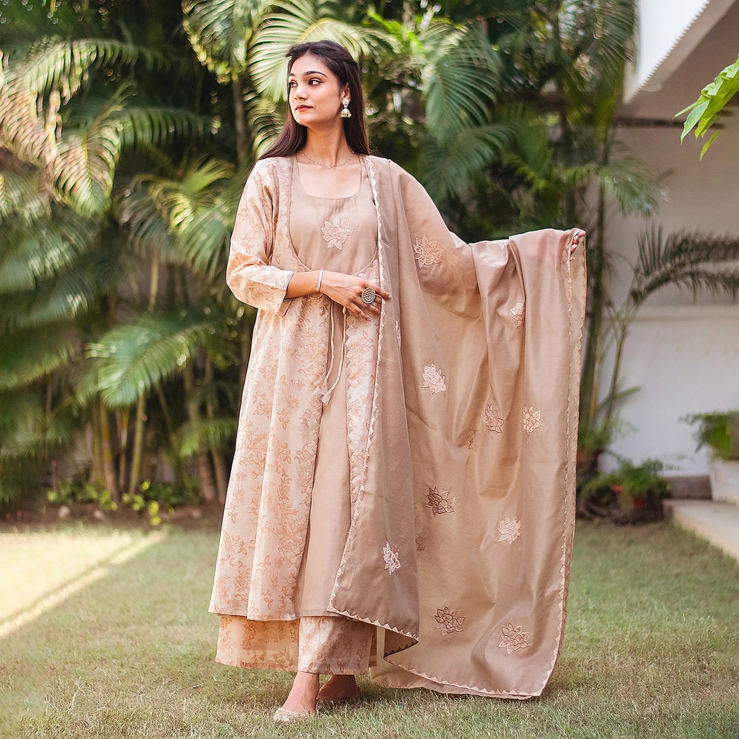 Model wearing the beige floral print kurta set in another elegant pose, showcasing the ensemble's style
