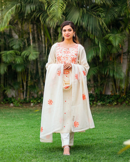 Model in an off-white embroidered kurta with matching dupatta and trousers.