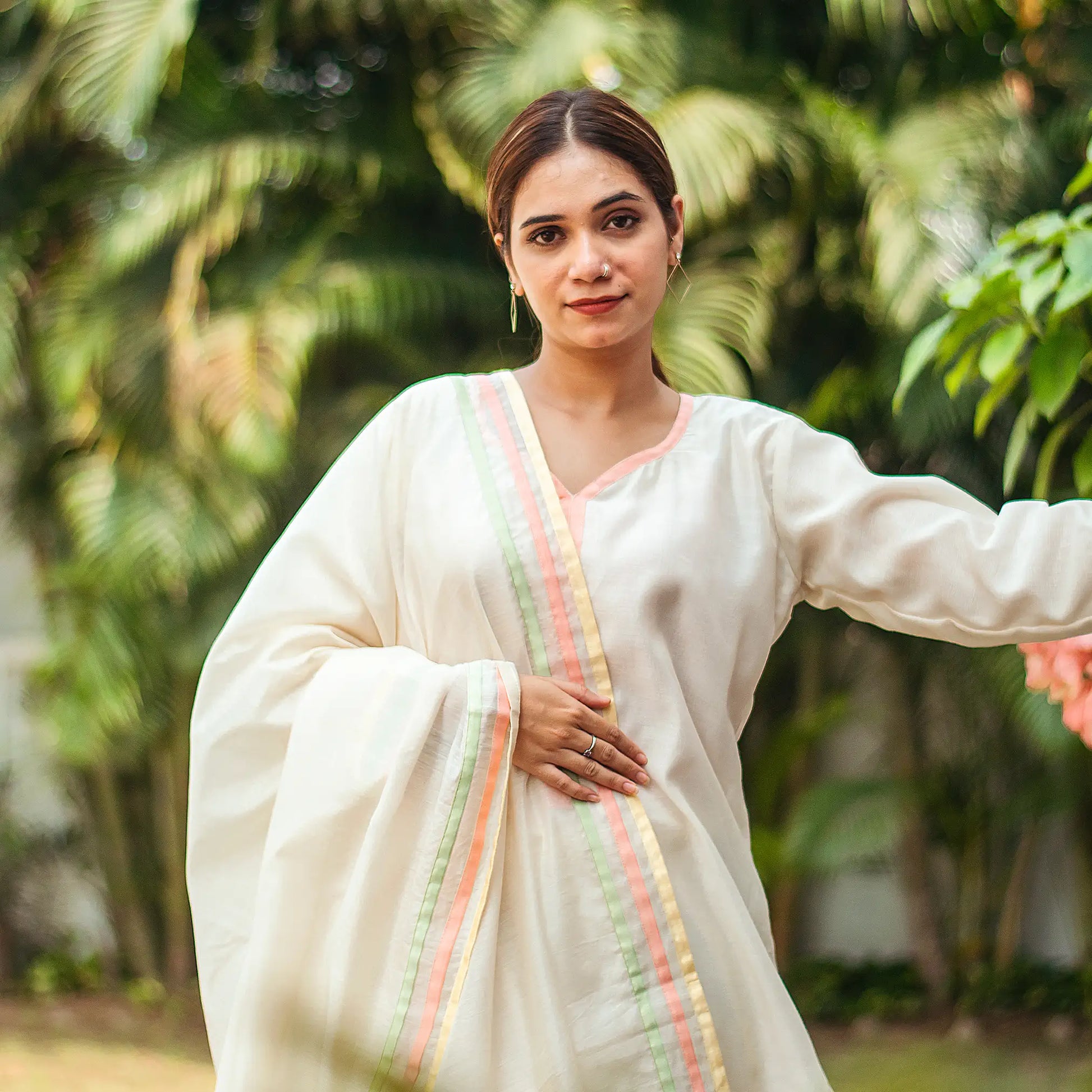 1) Close-up of an Indian model wearing an off-white chanderi kurta and matching dupatta with pastel patchwork motifs.