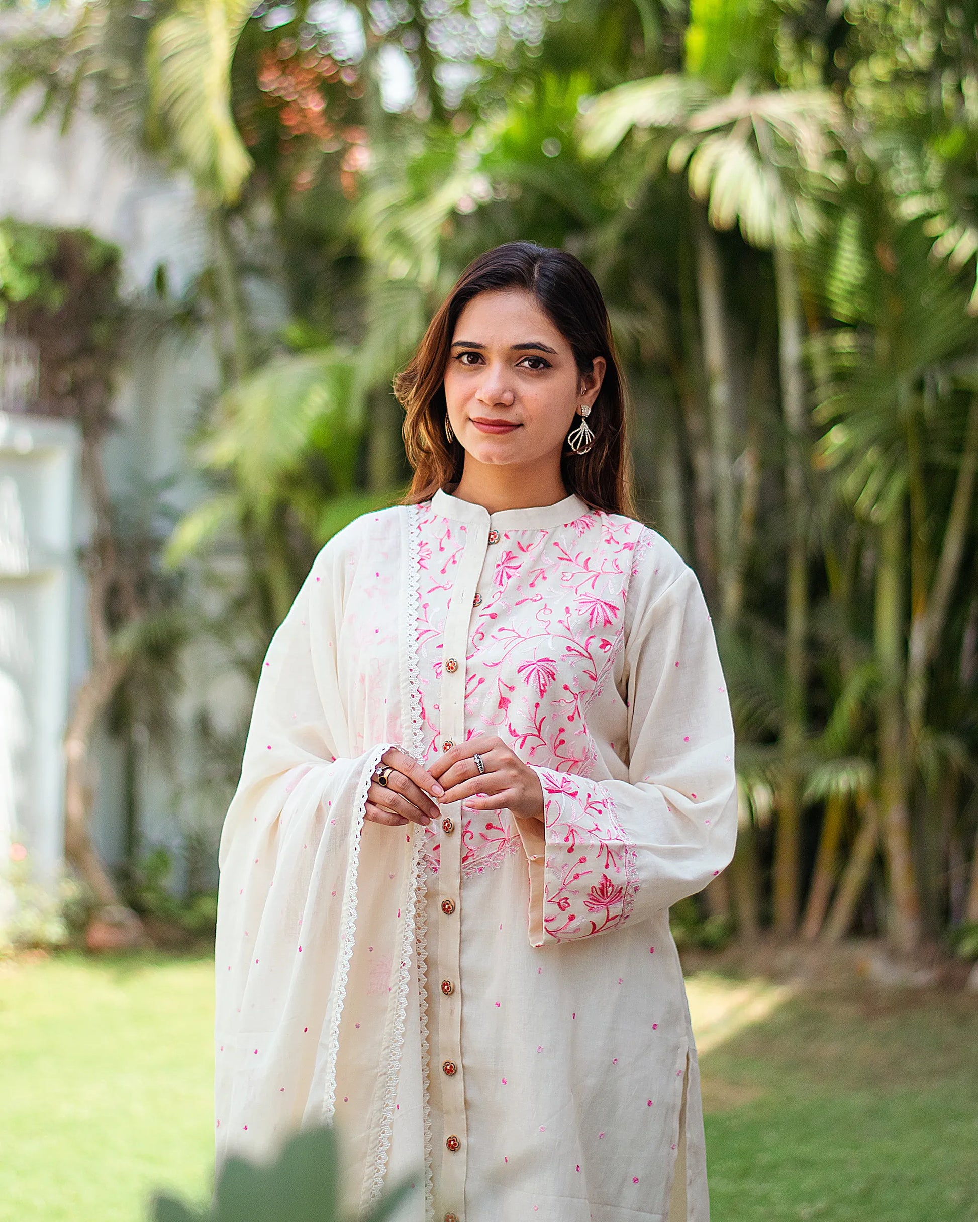 Close-up of an Indian model wearing an embroidered kurta and dupatta.