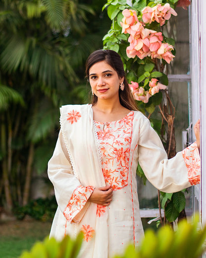 Detailed view of the kurta and dupatta, highlighting the peach embroidery.