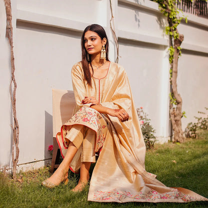  Indian model in a beige silk kurta adorned with resham embroidery, styled with a matching dupatta and beige trousers.