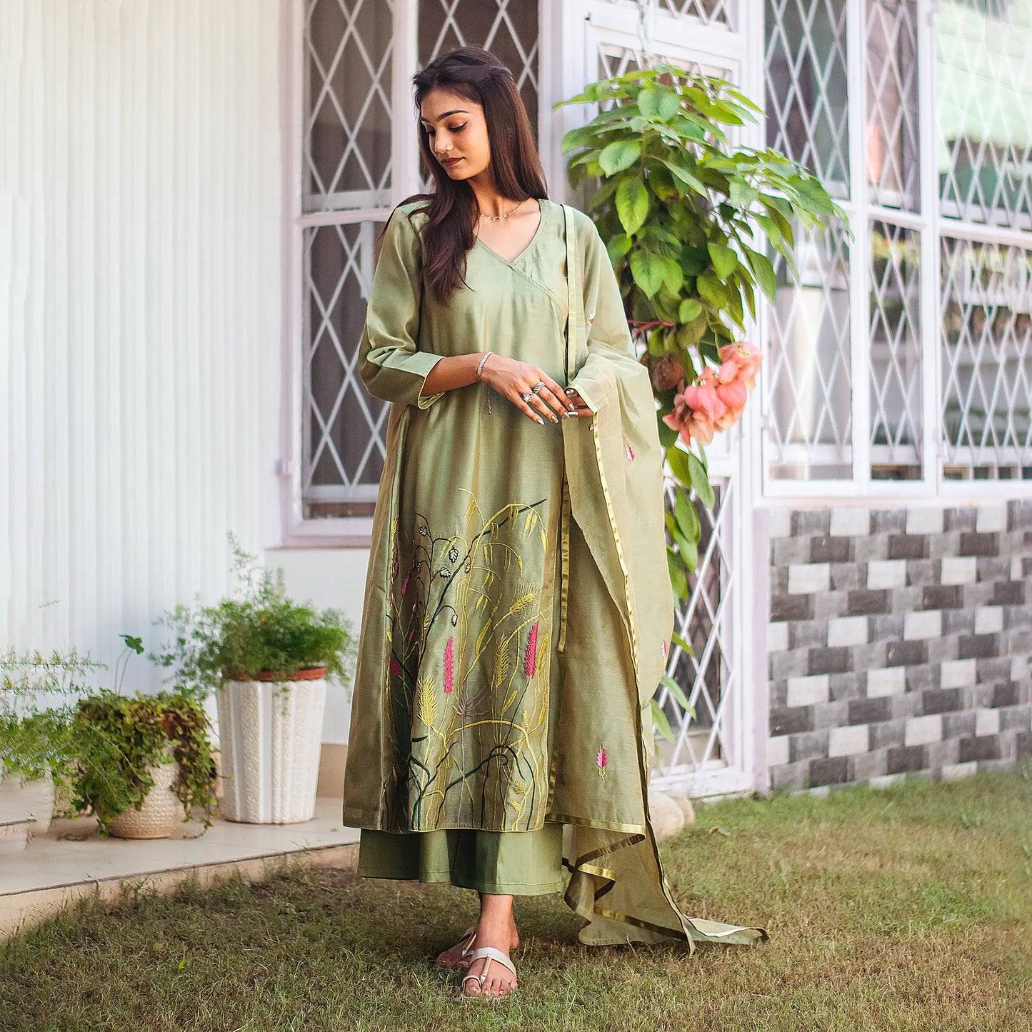 Model wearing the green kurta set in an elegant another pose, showcasing the ensemble's style