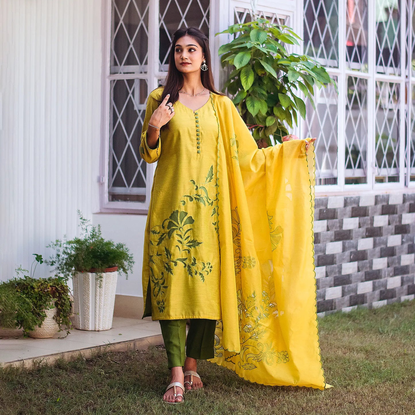 Complete ensemble of the green cutwork kurta set, including the green chanderi kurta, dark green trousers and green chanderi cutwork dupatta, as worn by the model