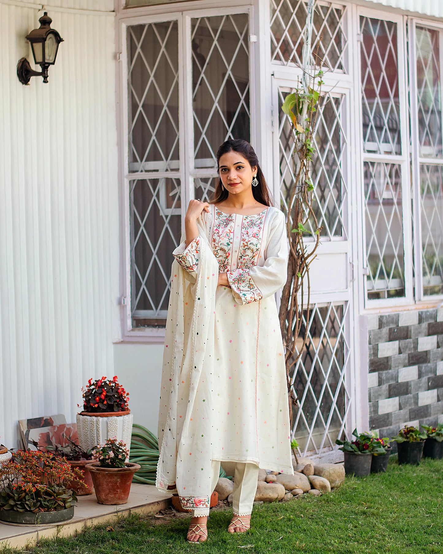 Model wearing an off-white embroidered kurta set with a Kashmiri embroidered dupatta.