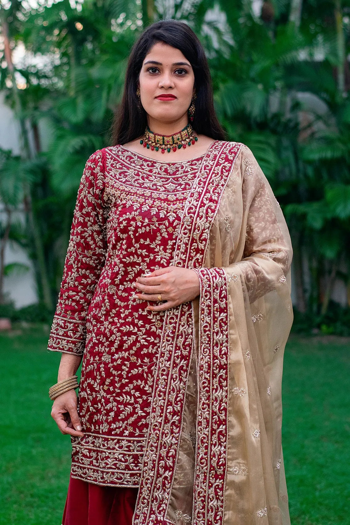 Indian women in maroon silk gharara with tissue dupatta