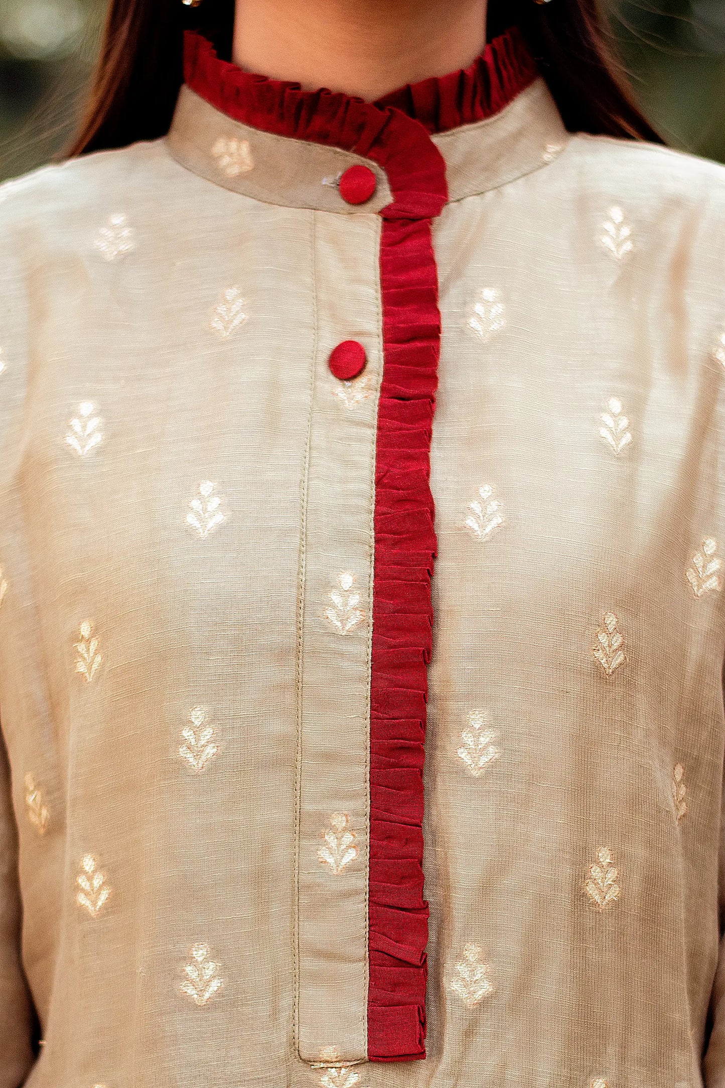 Close-up of the chest area of a linen kurta, showcasing the intricate taupe zari weave pattern