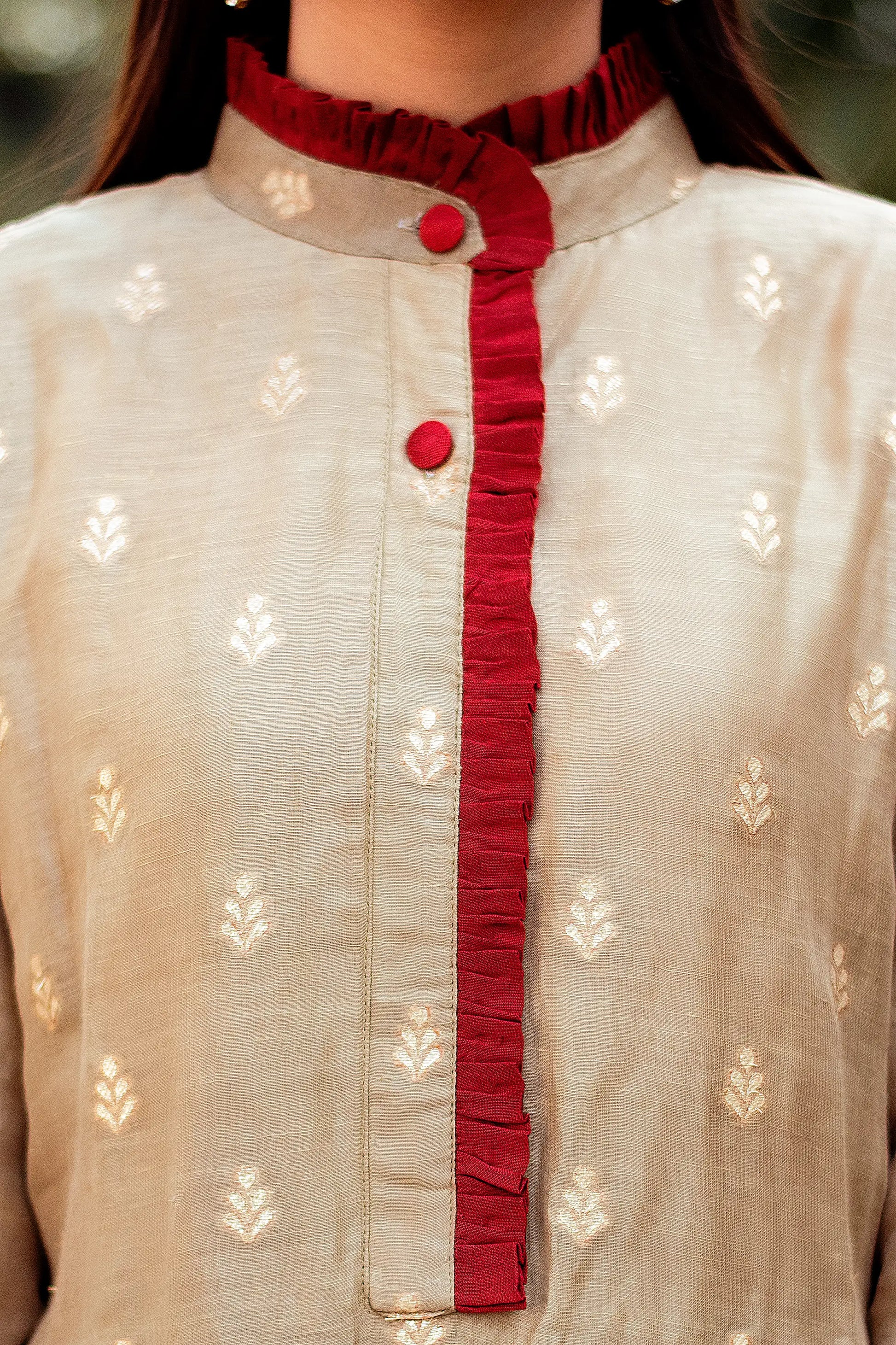 Close-up of the chest area of a linen kurta, showcasing the intricate taupe zari weave pattern