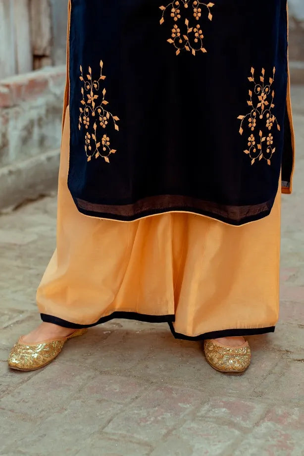 An Indian girl in a pose with only lower half dark blue chanderi kurti and palazzo are visible.