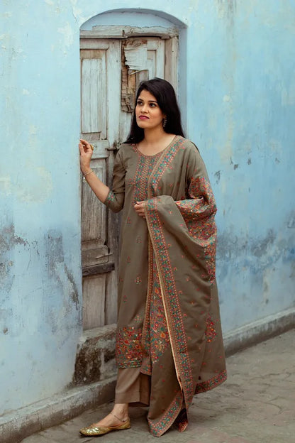 A model wearing a Cotton Kani Suit with silk-woven taupe kurta, matching dupatta, and trousers.