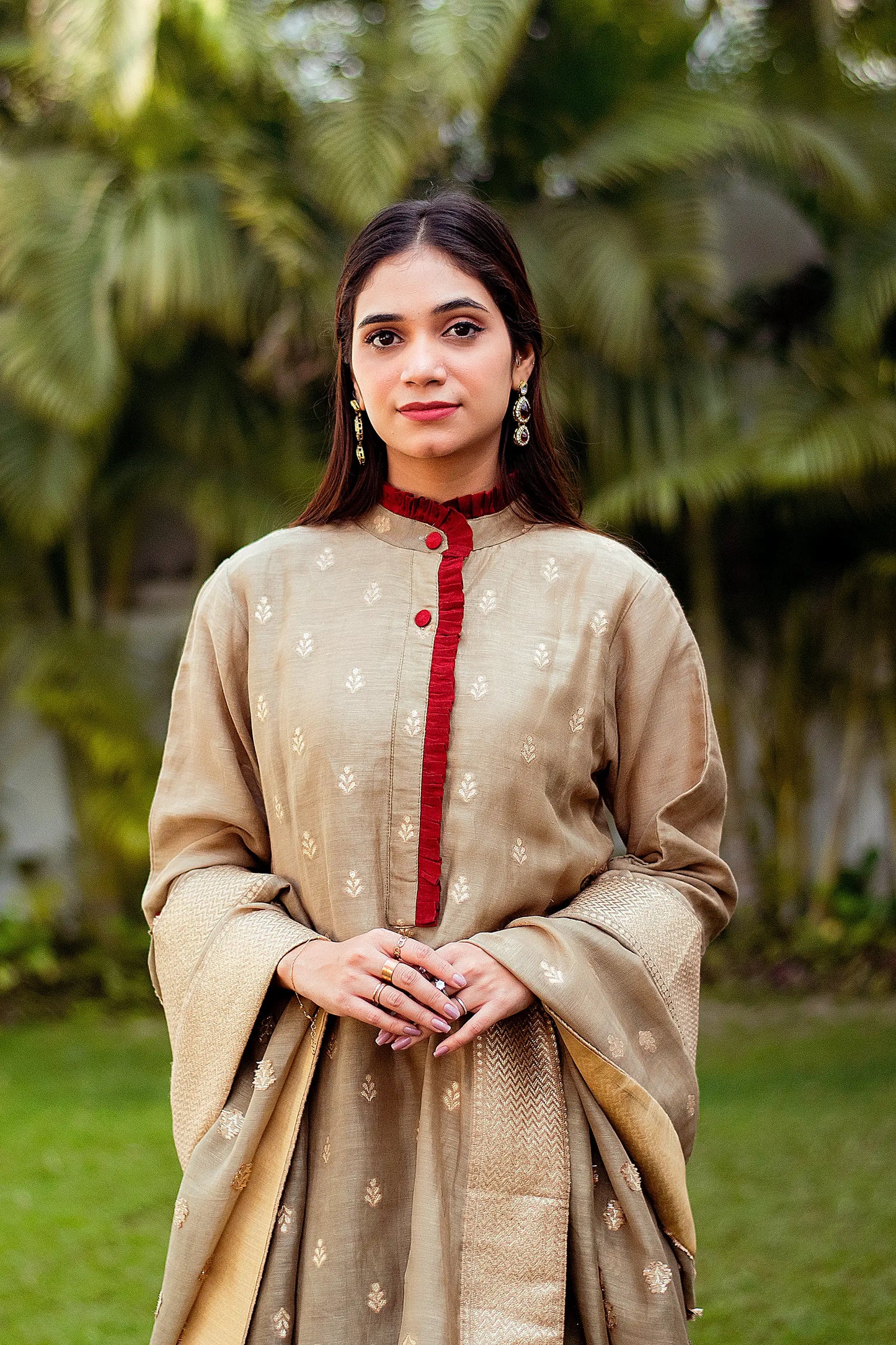 Closeup of a model wearing a linen kurta with a beautiful taupe zari weave pattern