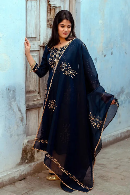 Full length pose of an indian model wearingdark blue chanderi kurti and dupatta with applique work paired with golden palazzo.