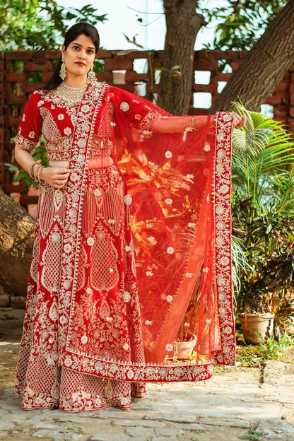 Red velvet zardozi embroidered lehenga and blouse with net dupatta