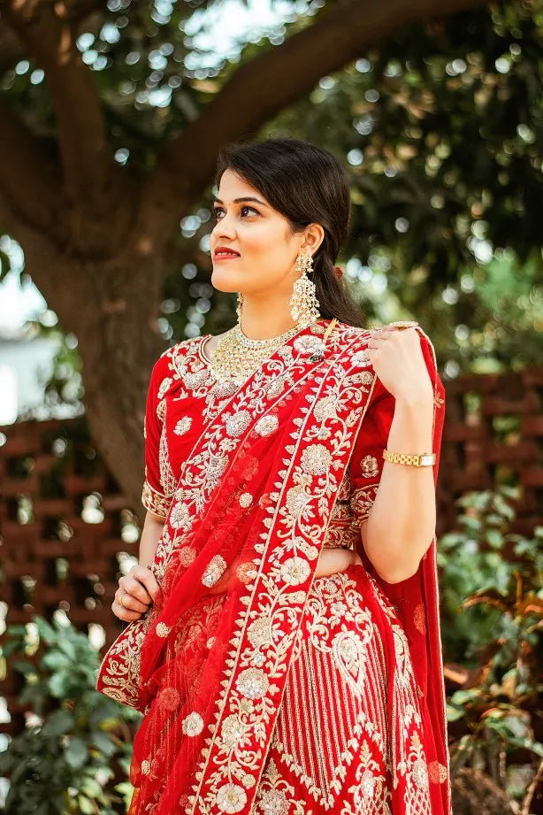 Red velvet zardozi embroidered lehenga and blouse with net dupatta