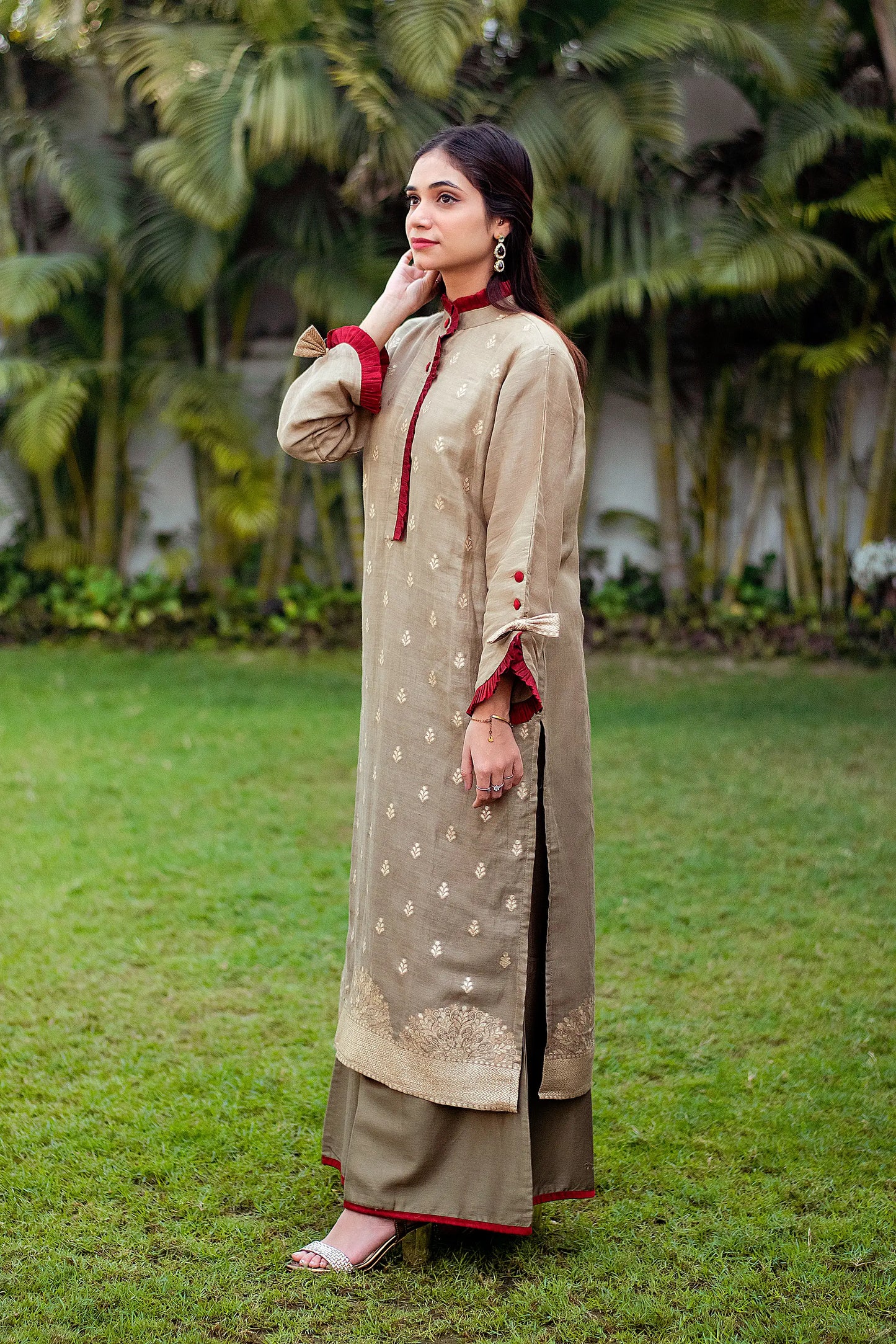 A model in a side pose, wearing a linen kurta with a beautiful taupe zari weave pattern