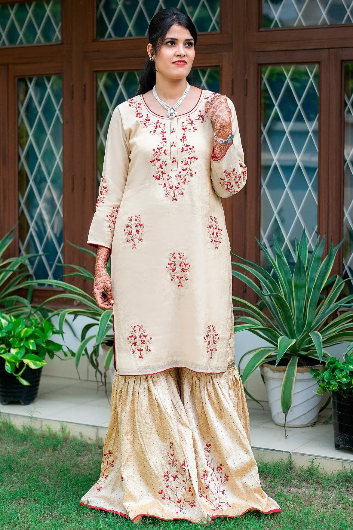 Experience the beauty of traditional attire with a gold Gharara featuring delicate applique work.