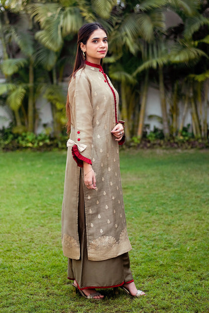 An Indian model in a side pose, showcasing a linen kurta with a beautiful taupe zari weave pattern