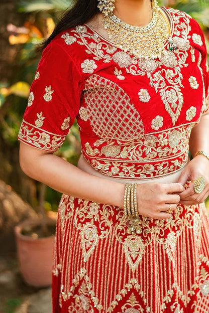 Red velvet zardozi embroidered lehenga and blouse with net dupatta