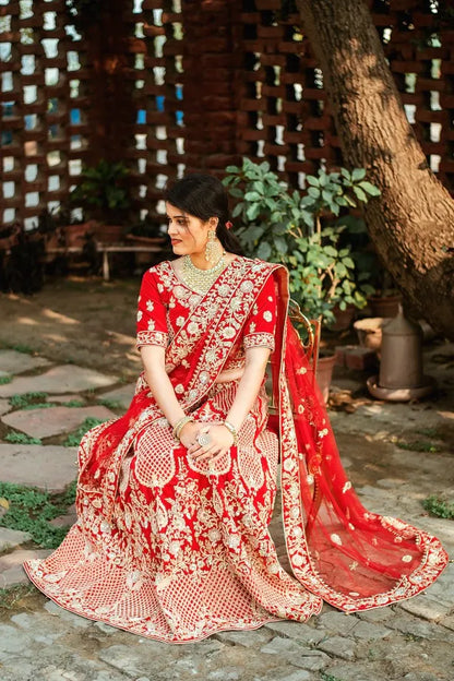 Red velvet zardozi embroidered lehenga and blouse with net dupatta