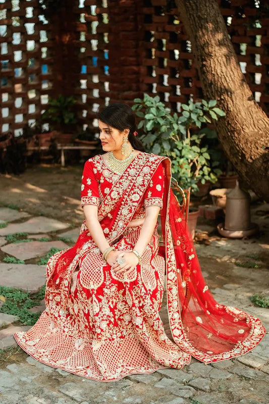 Red velvet zardozi embroidered lehenga and blouse with net dupatta