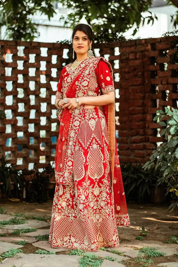 Red velvet zardozi embroidered lehenga and blouse with net dupatta