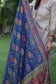 A solo female dons a beige kurta with a blue silk jamawar dupatta, looking serene.