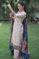 A beige kurta with a blue silk jamawar dupatta is worn by a woman in a rustic setting.