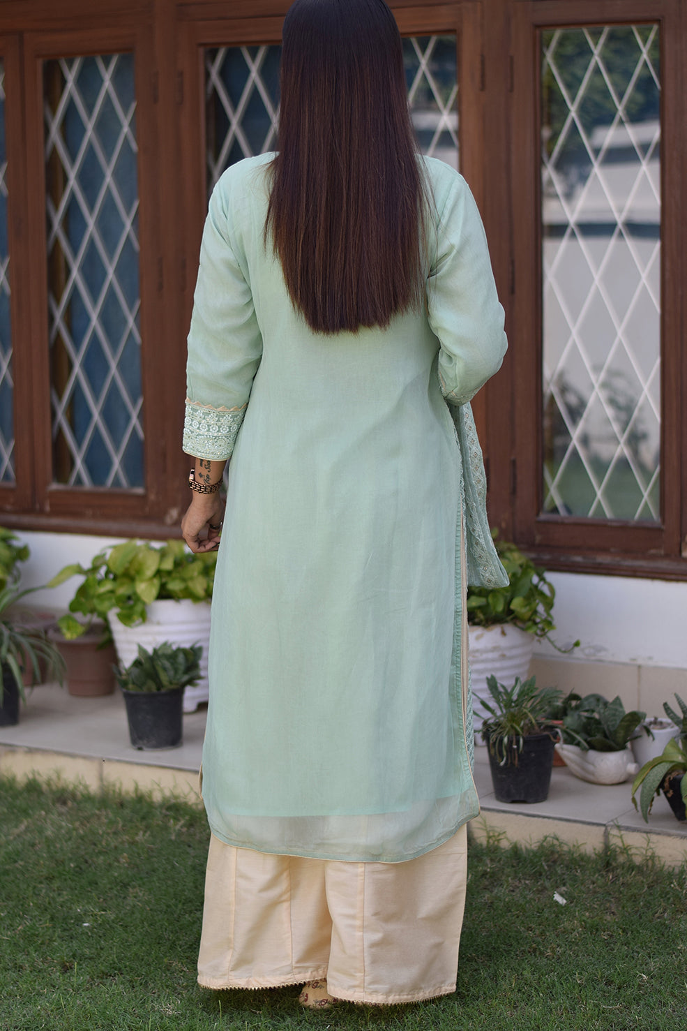 A stylish solo female wearing a green chikankari kurta set.