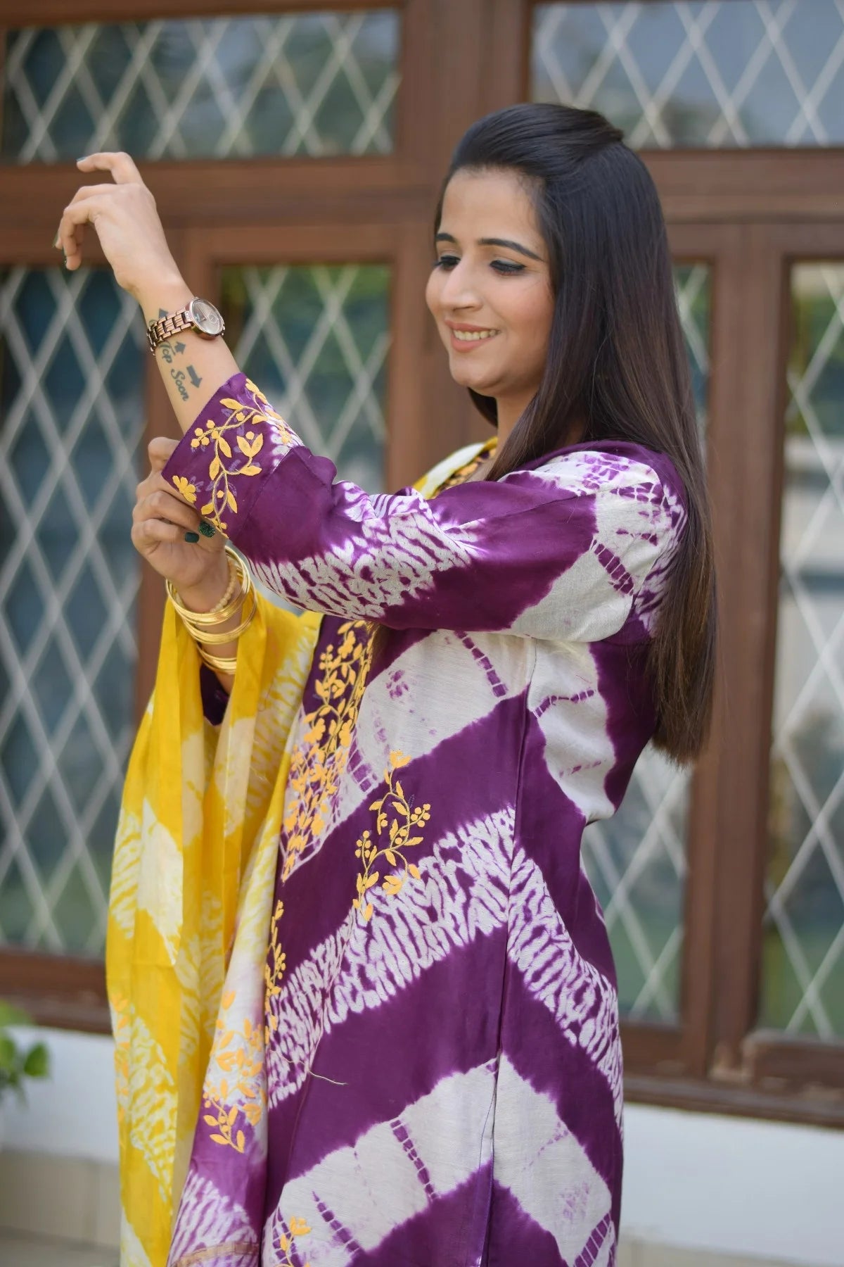 A striking traditional outfit for women featuring a purple and yellow maheshwari kurta and dupatta, accessorized with yellow palazzo pants for a contemporary touch.