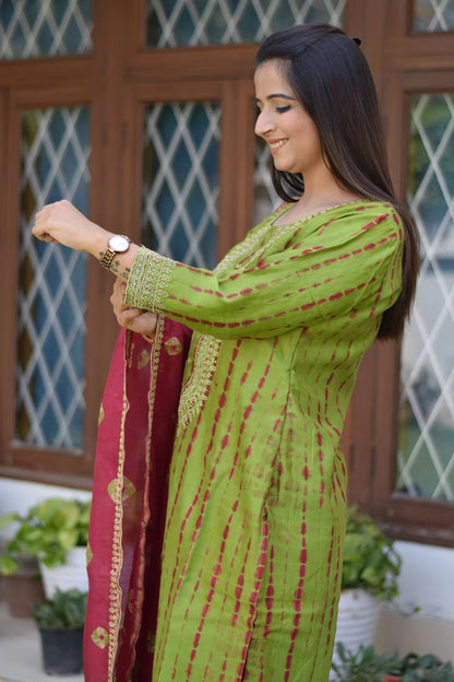 A fashionable woman dressed in a striking zari hand work suit that exudes elegance.