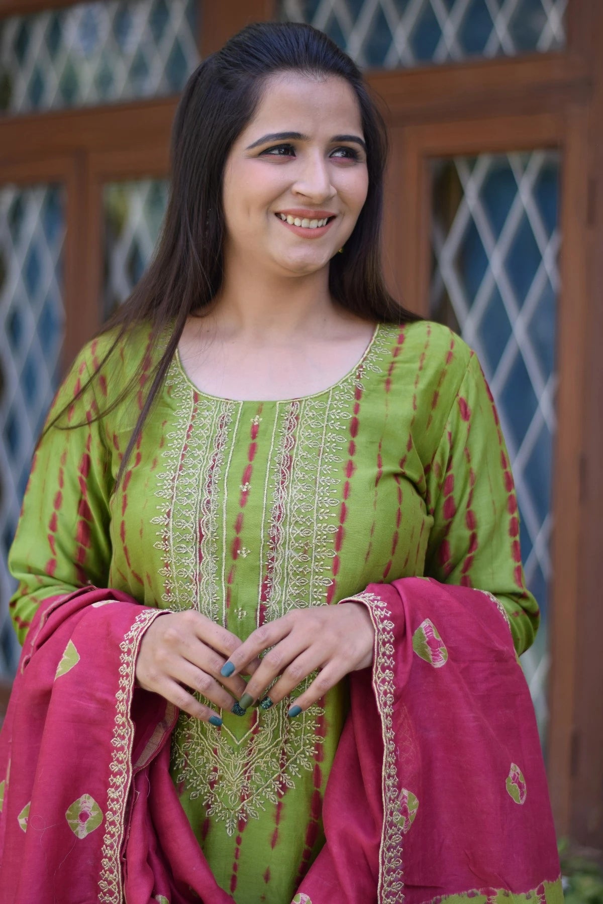 A graceful woman donning a zari hand work suit, the epitome of traditional Indian attire.