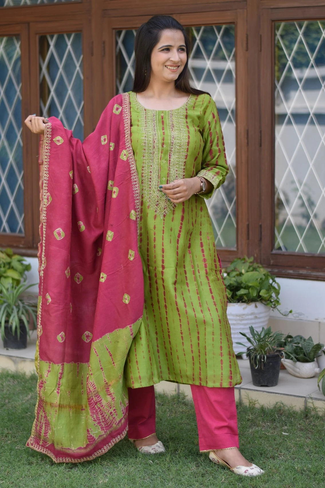 A fashionable lady dressed in a zari hand work suit, perfect for any festive occasion.