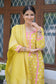 A woman wearing a bright yellow Banarasi cotton silk kurta with intricate designs.