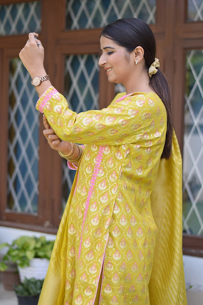 A woman wearing a sunny yellow Banarasi cotton silk kurta, looking stylish and comfortable.