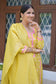 A female fashionista rocking a yellow Banarasi cotton silk kurta with grace and poise.