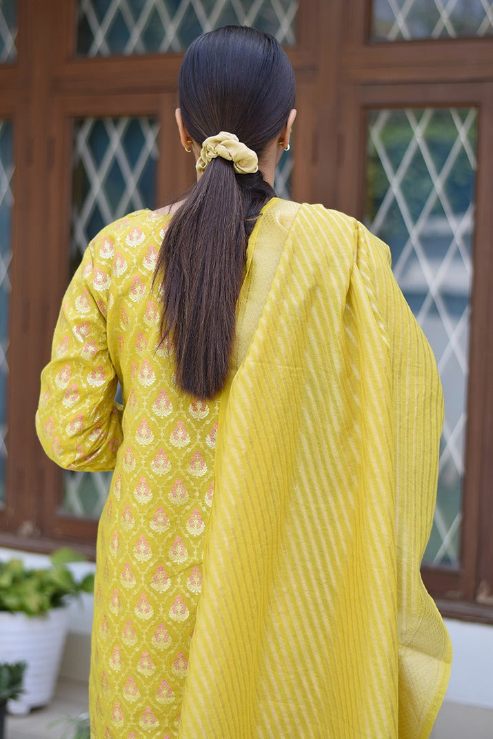 A girl flaunting her ethnic style in a vibrant yellow Banarasi cotton silk kurta.