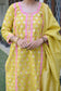 A lady looking resplendent in a yellow Banarasi cotton silk kurta, adorned with intricate motifs.