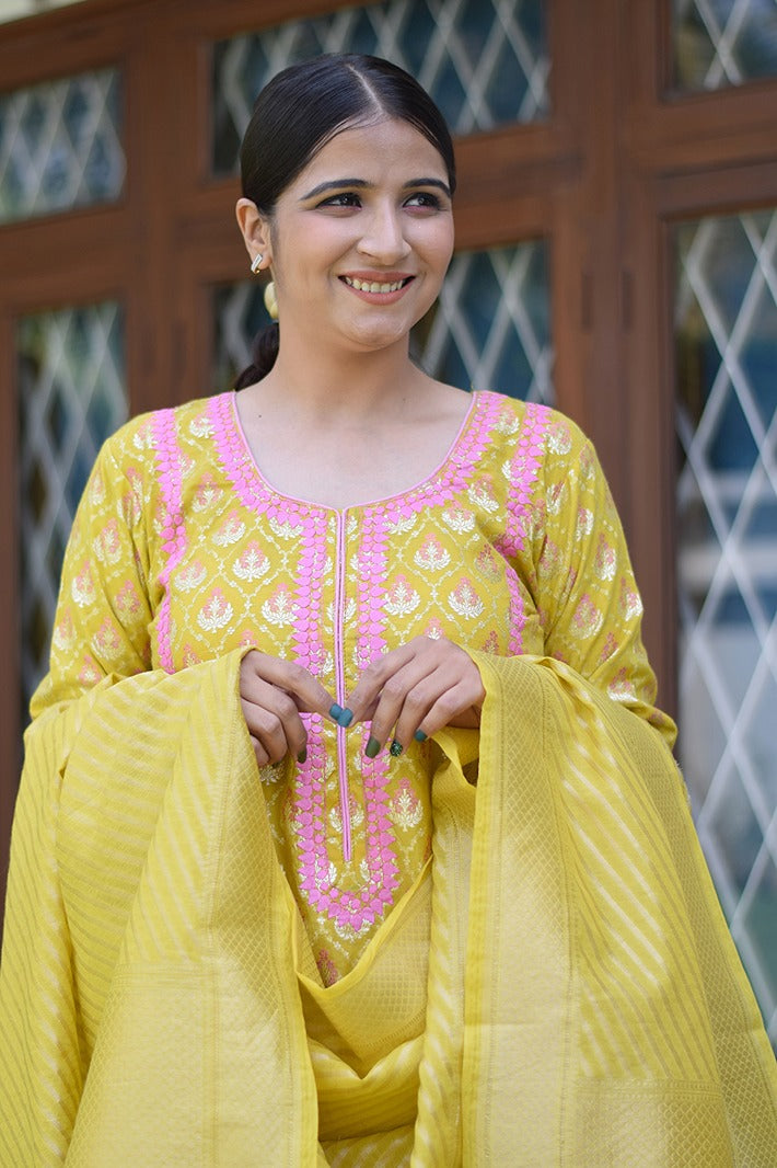A lady dressed in a stunning yellow Banarasi cotton silk kurta, perfect for any festive occasion.