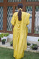 A fashion-conscious woman looking radiant in a yellow Banarasi cotton silk kurta.