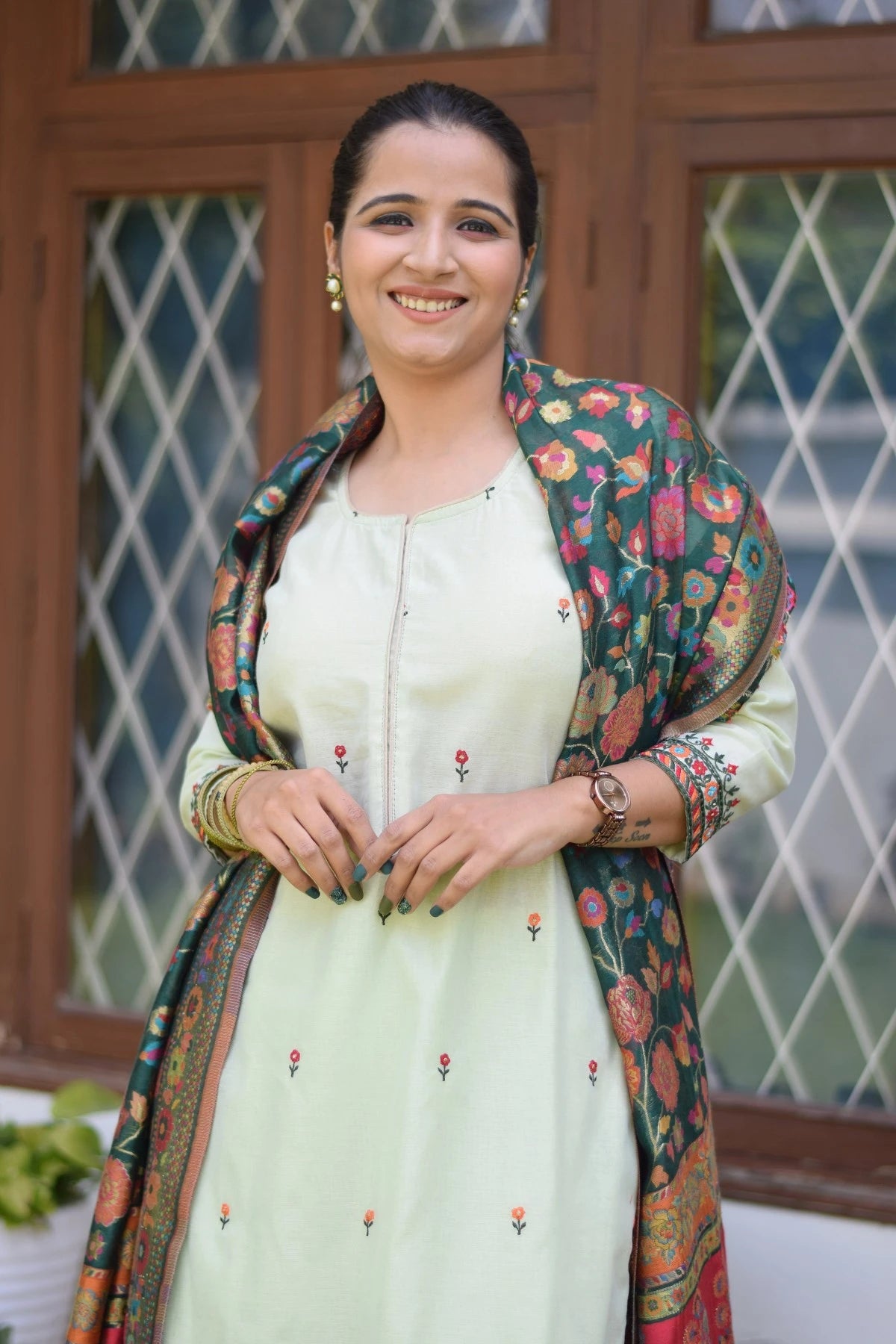 A classic ethnic attire of a woman in a green silk jamawar dupatta, chanderi resham embroidered kurta, and palazzo.