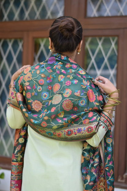 A woman in a lovely green silk jamawar dupatta and chanderi resham embroidered kurta and palazzo.