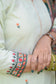 A beautiful outfit comprising a green silk jamawar dupatta, chanderi resham embroidered kurta, and palazzo on a woman.