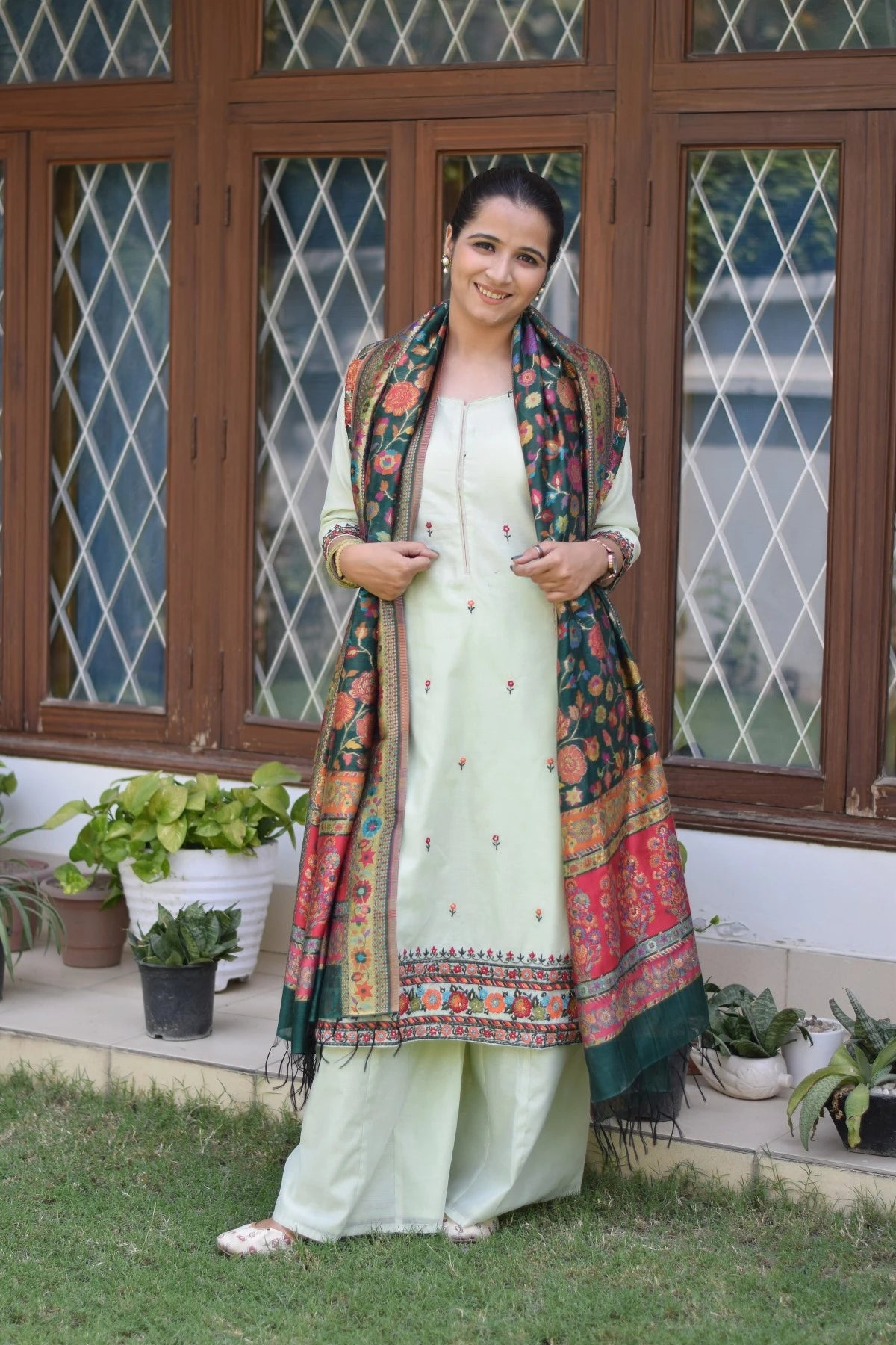 Traditional ethnic attire of a woman with green silk jamawar dupatta, chanderi resham embroidered kurta, and palazzo.