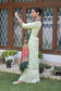 An elegant ensemble consisting of a green silk jamawar dupatta, chanderi resham embroidered kurta, and palazzo on a woman.